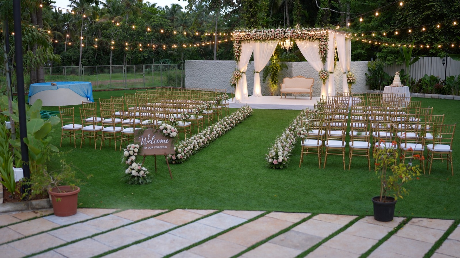 Outdoor garden wedding venue Jasmine Lawn at Kannur Gardens with lush greenery and night wedding decoration in Kannur Kerala